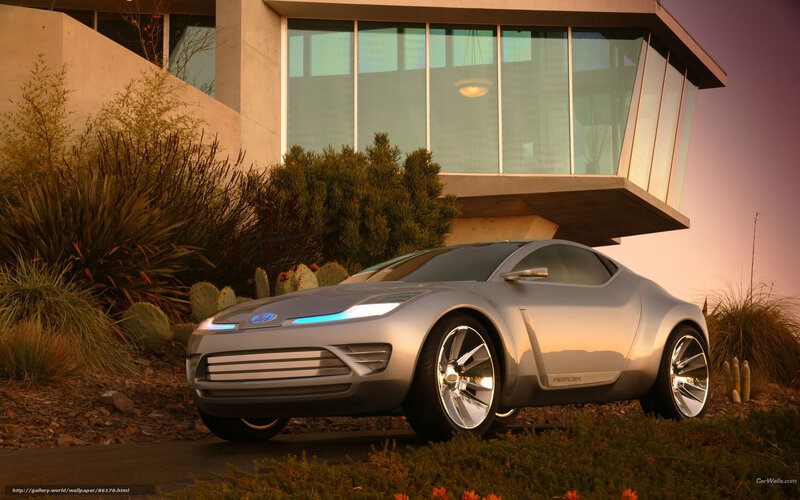 Silver concept car at modern house