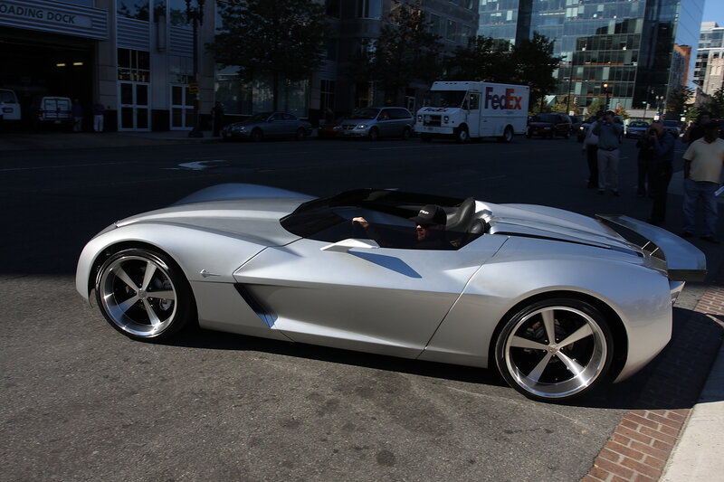 Silver concept car on city street