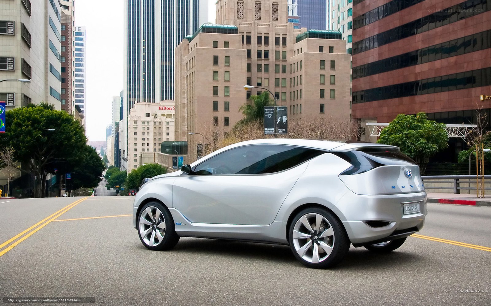 Silver concept car on city street