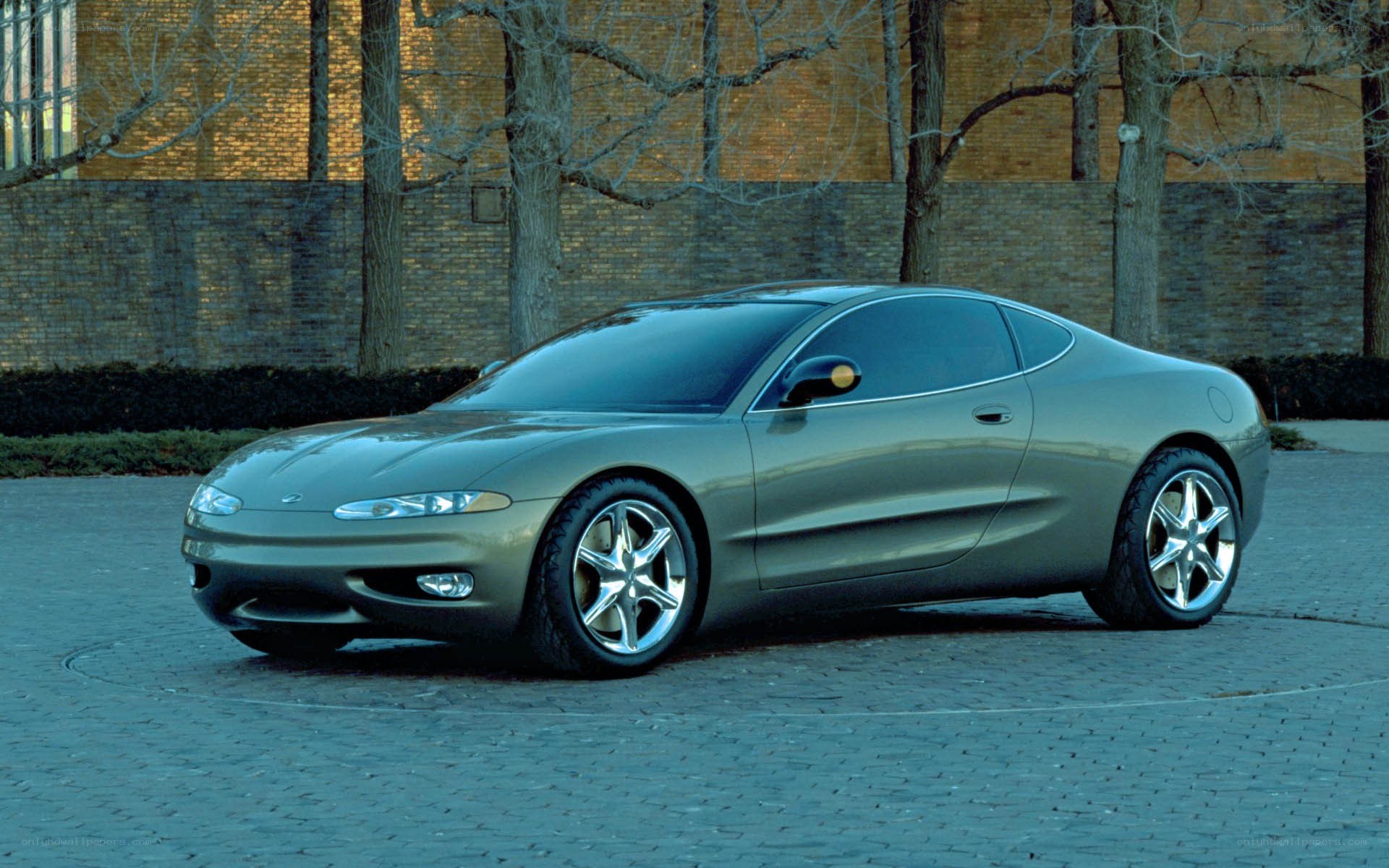 silver concept car on cobblestones