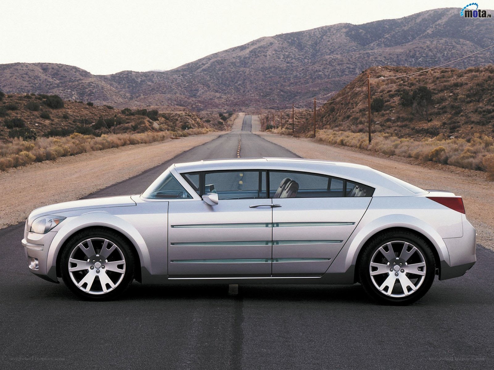 silver concept car on desert road