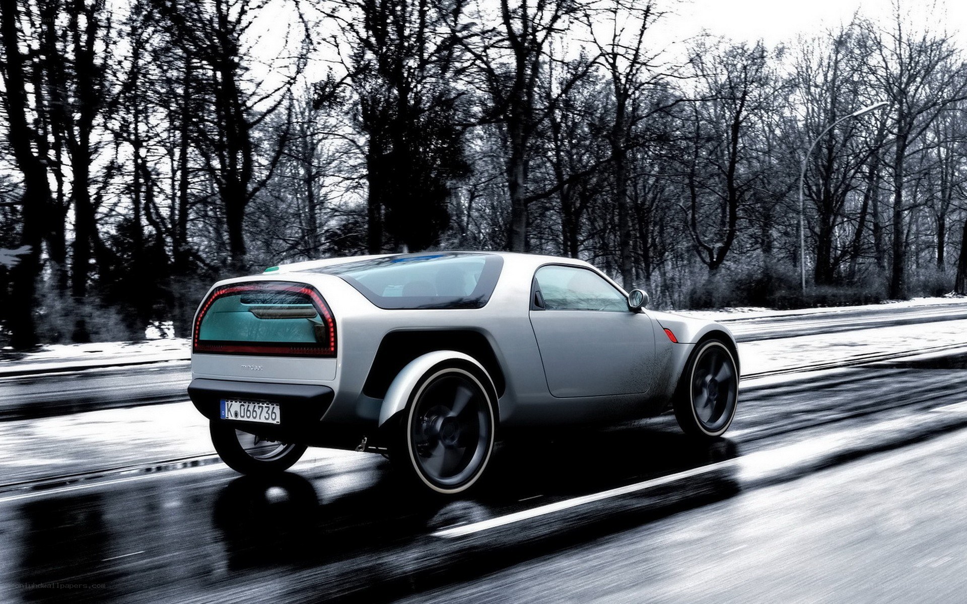 Silver concept car on wet road