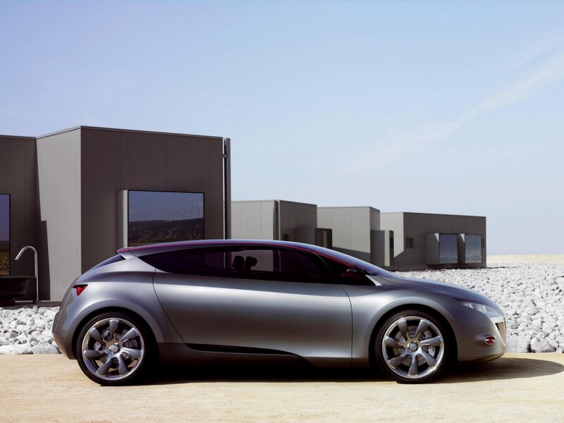 Silver Concept Car — Serene, Afternoon, Photograph, Modern Building, Wind Turbines