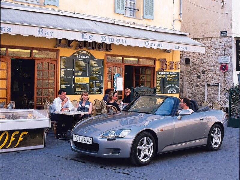 Silver convertible at a French café