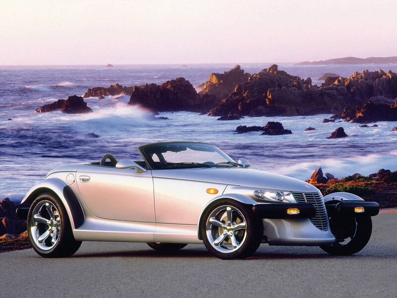 Silver convertible by the coast