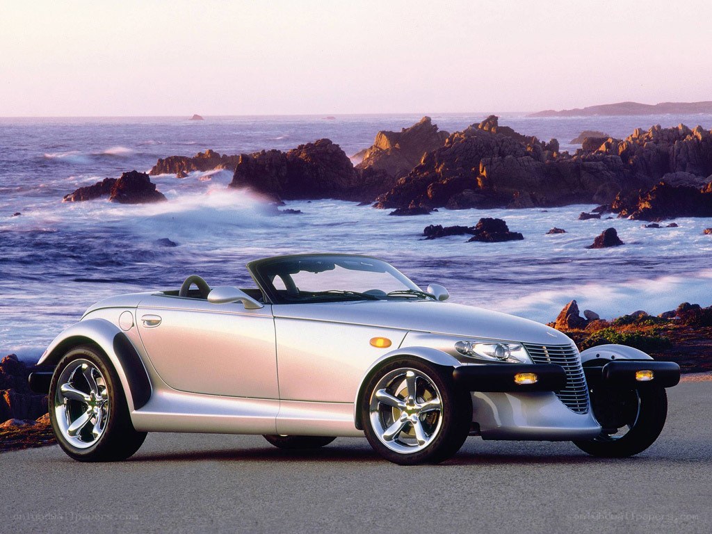 Silver convertible by the coast
