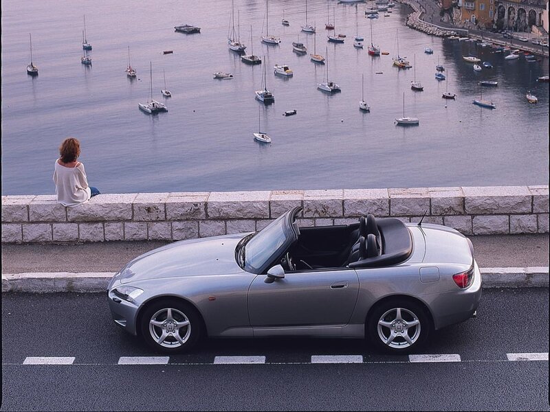 Silver convertible by the harbor