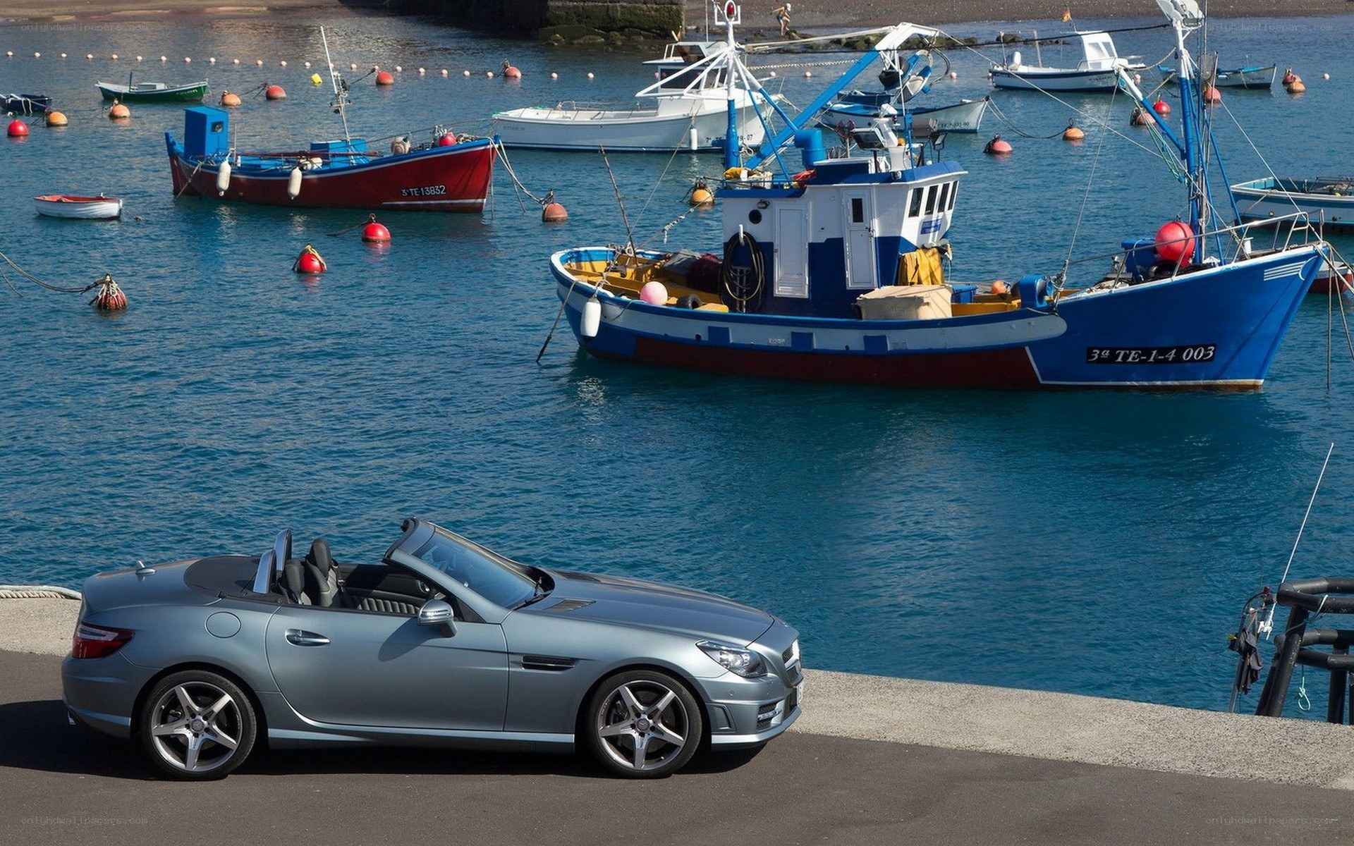 Silver convertible by the harbor