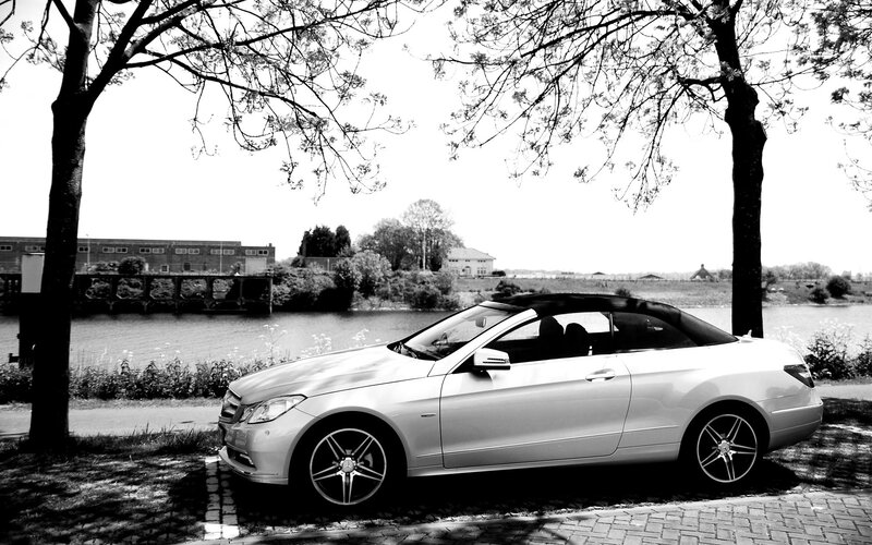 Silver convertible by the river