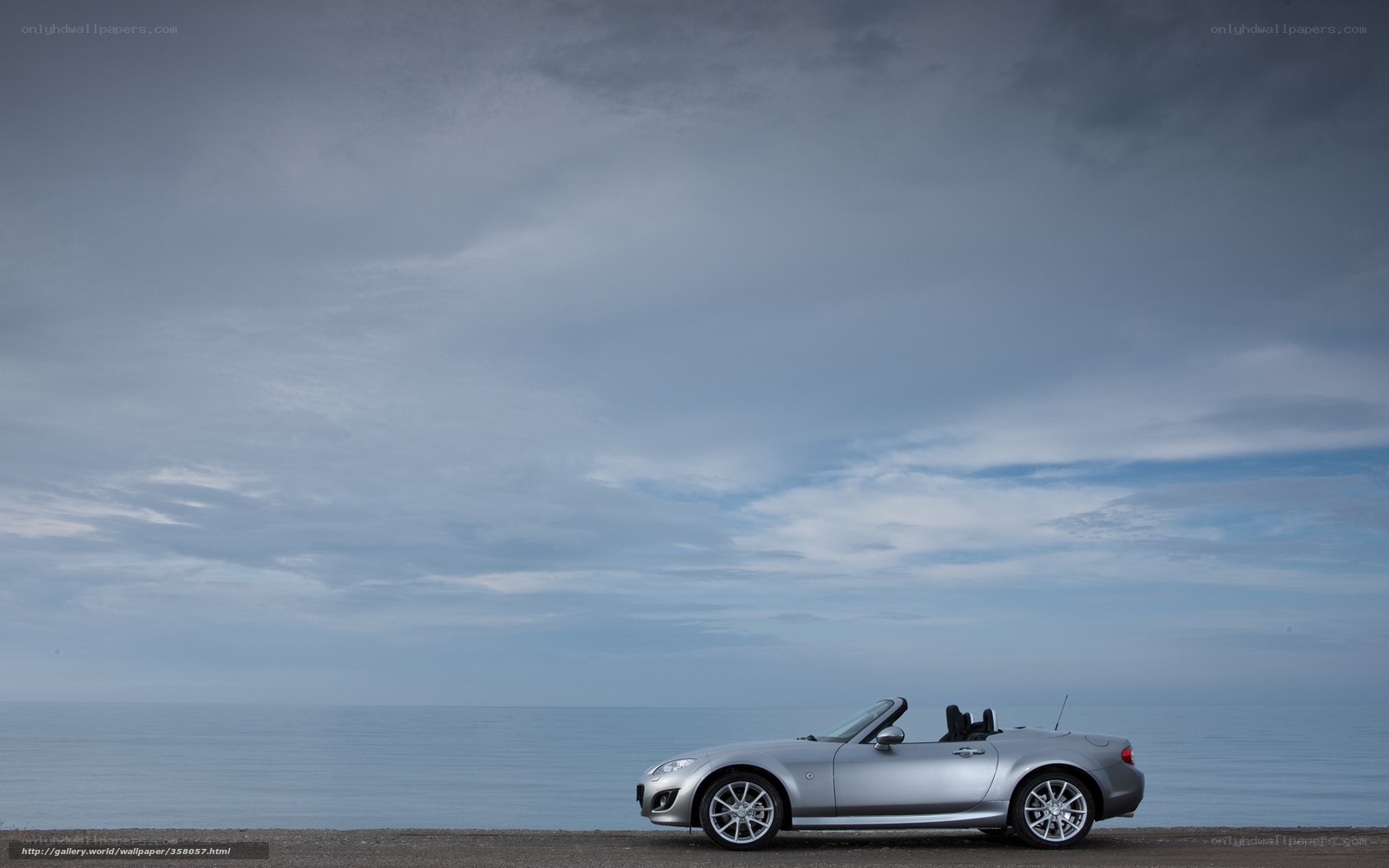 Silver convertible by the sea
