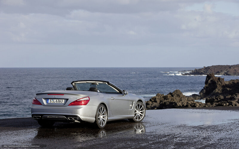 Silver convertible by the sea