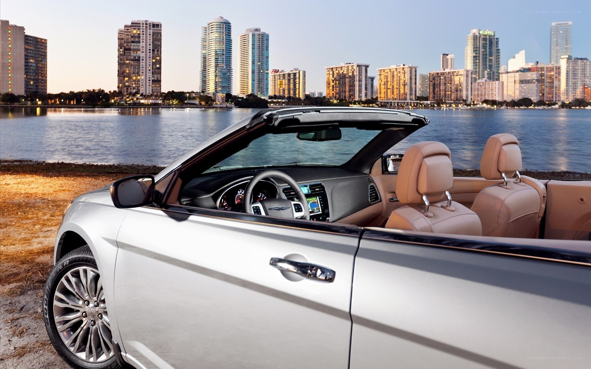 Silver convertible by the water