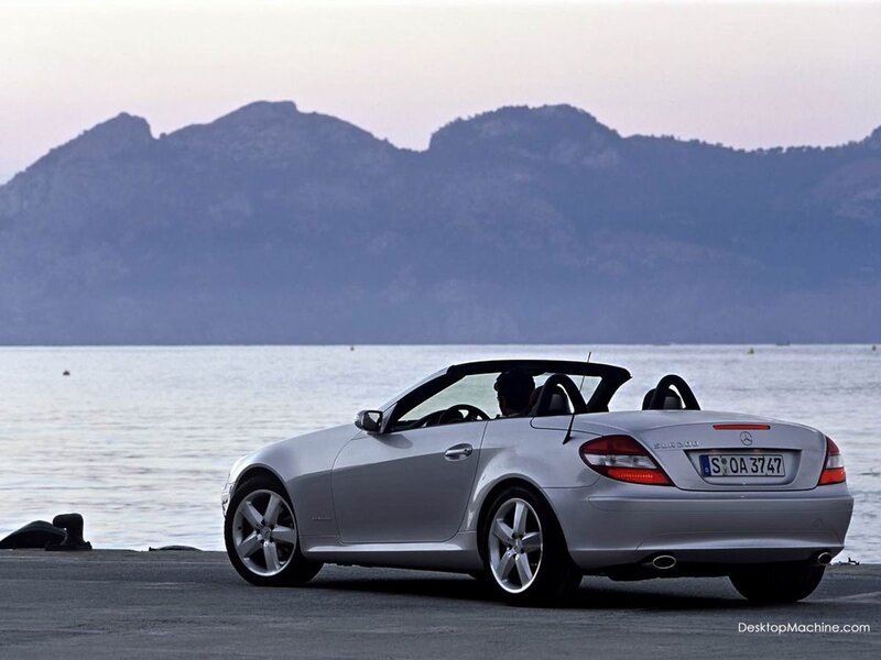Silver convertible by the water
