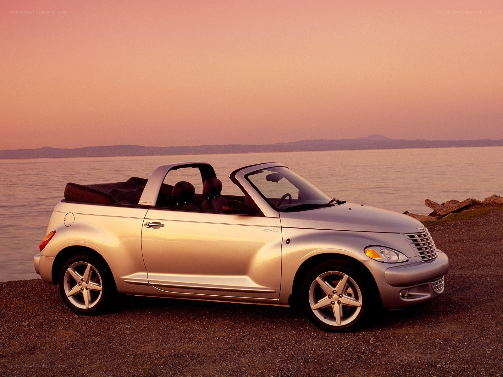 Silver convertible by the water