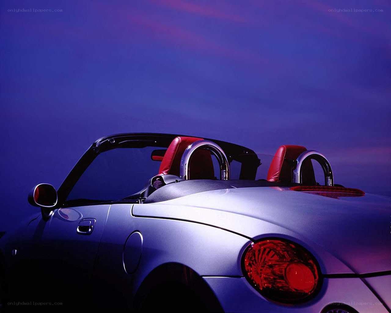 Silver convertible car at dusk