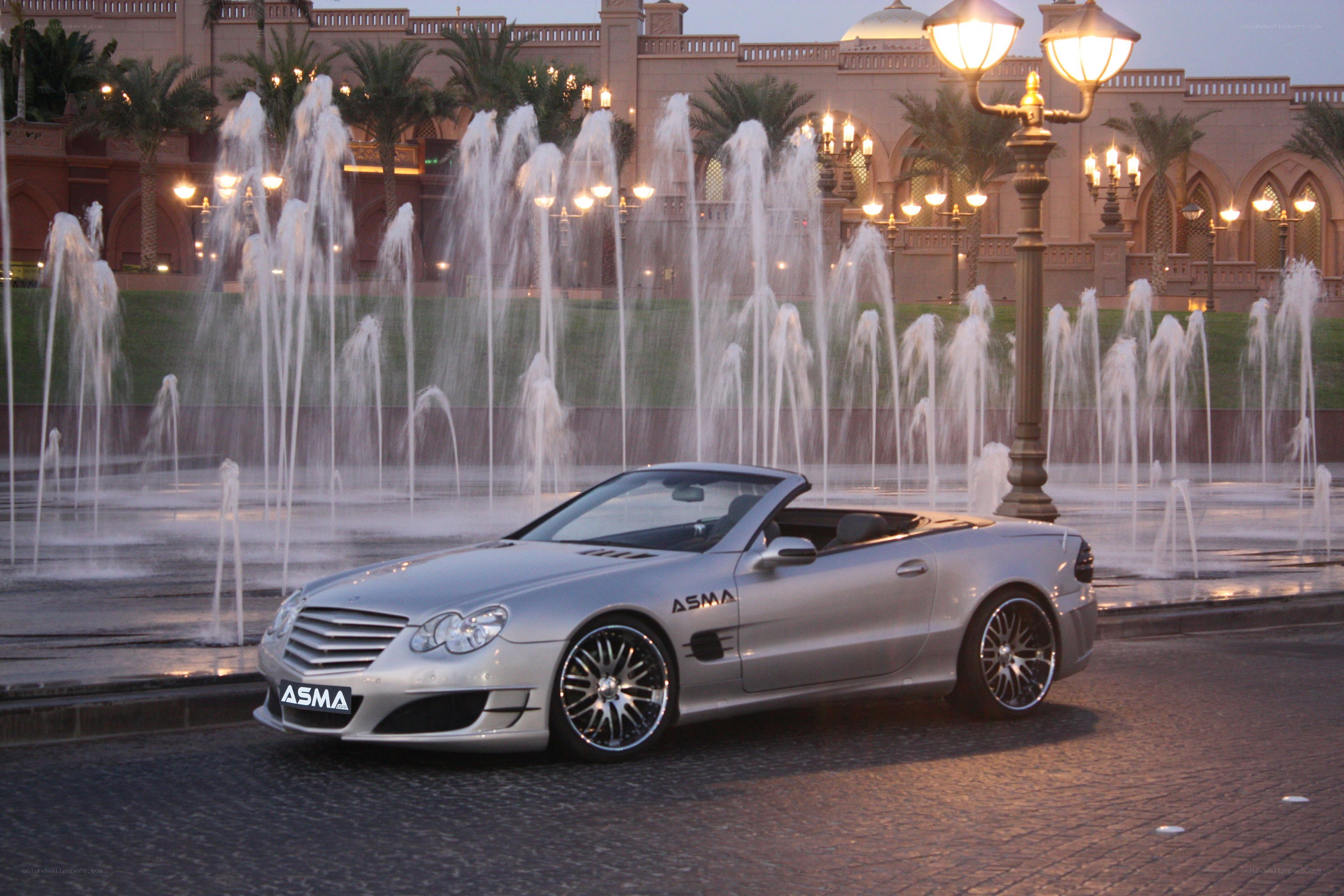 Silver convertible car at fountain