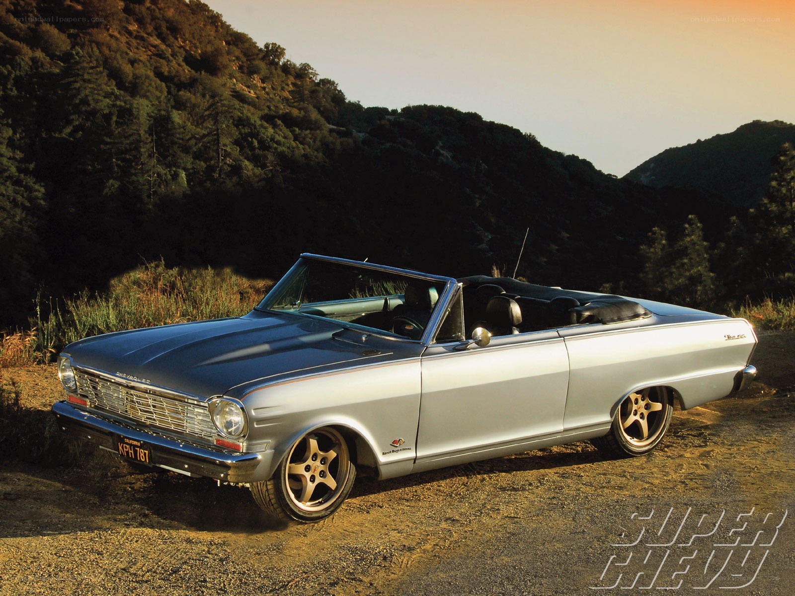Silver convertible car on a hillside