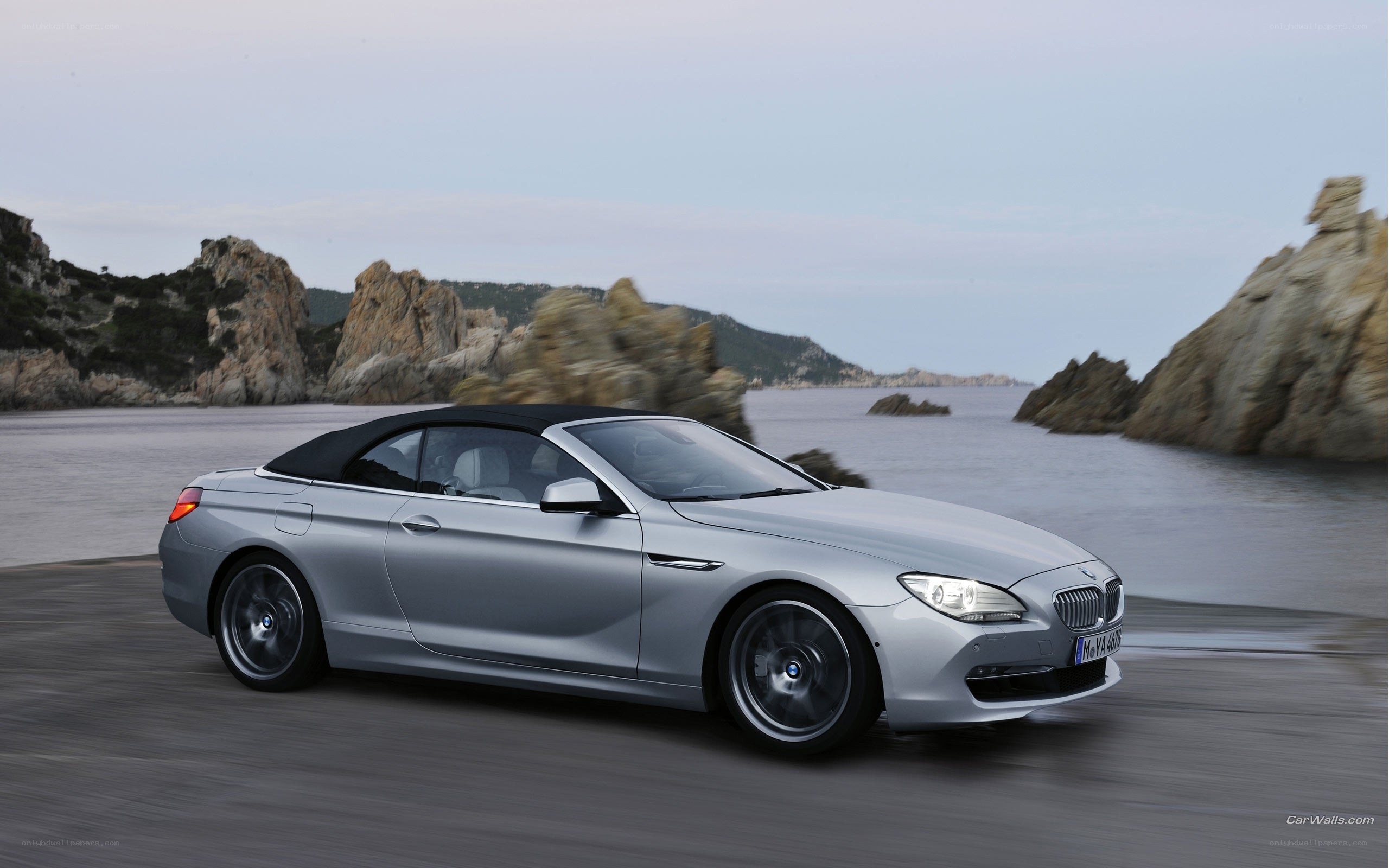 silver convertible car on coastal road