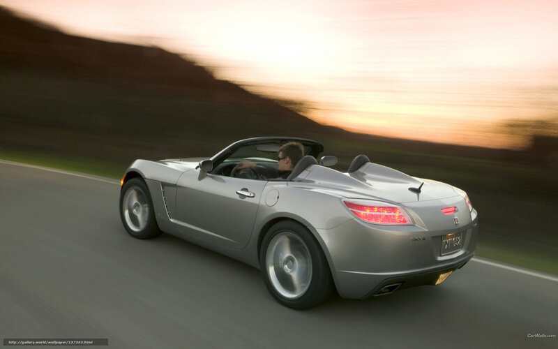 silver convertible driving at sunset