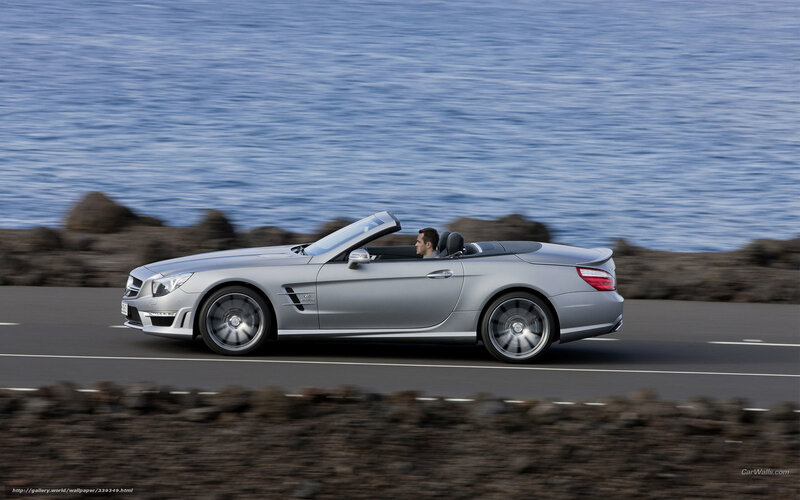 silver convertible driving by sea
