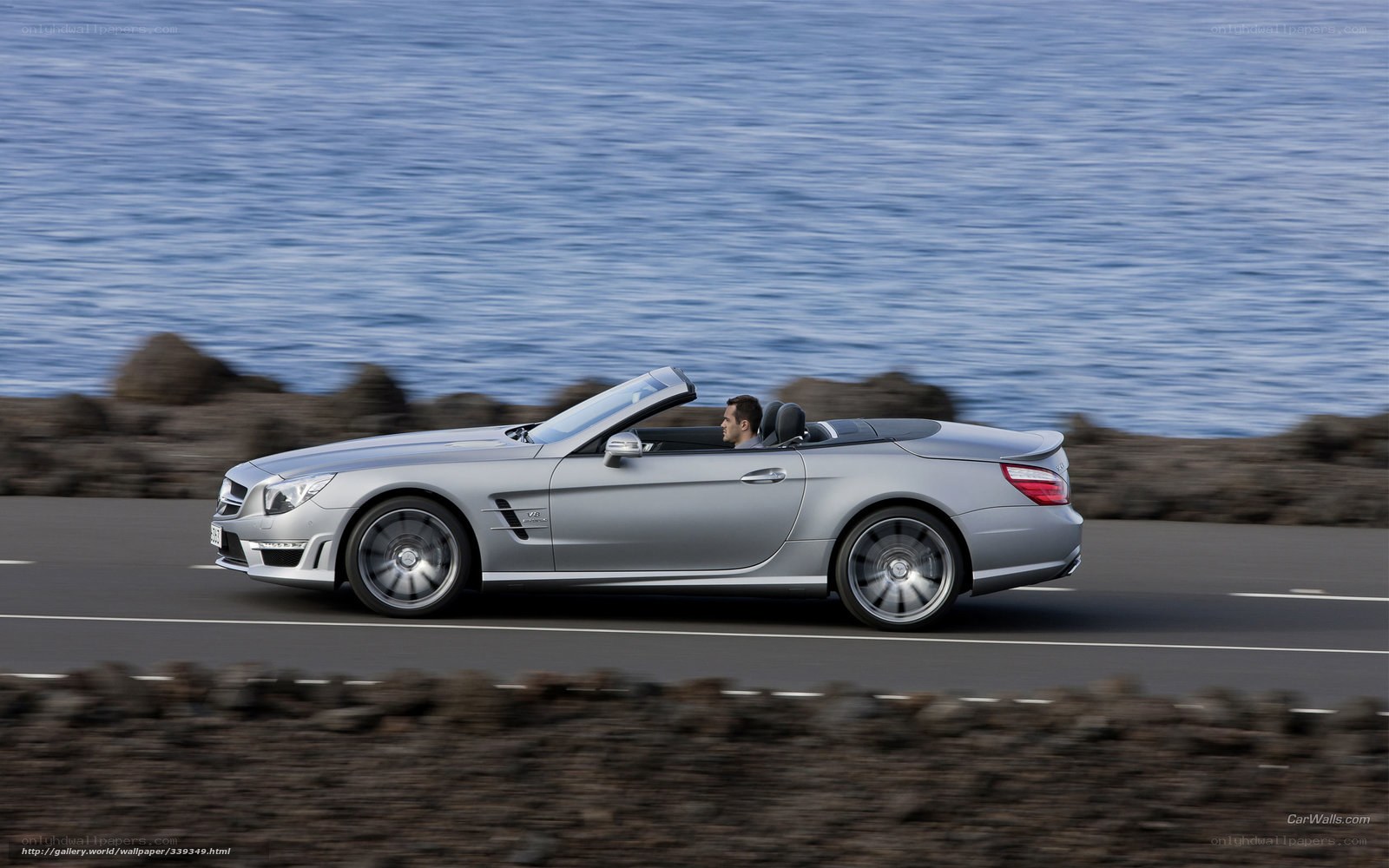 silver convertible driving by sea