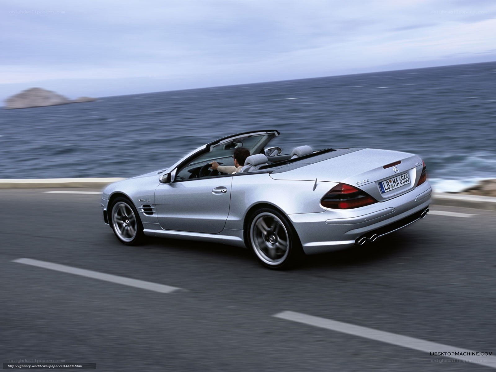 silver convertible driving by sea