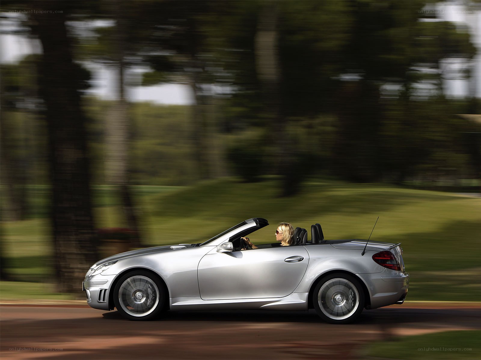 Silver convertible driving on road