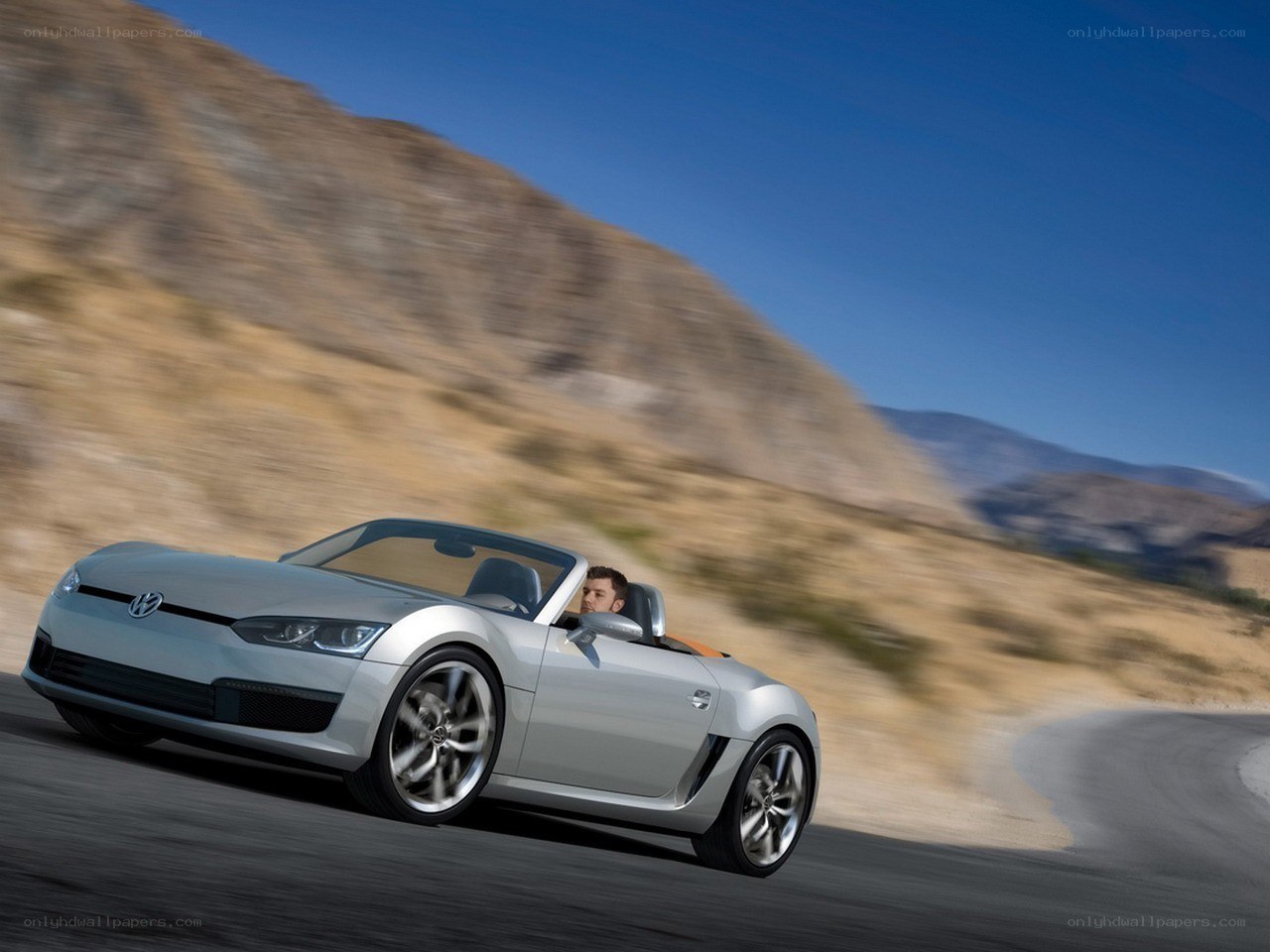 Silver convertible driving on road