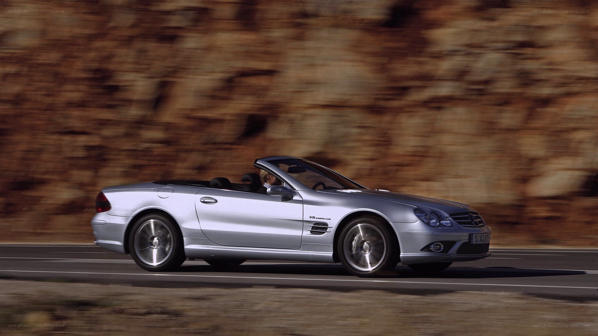 silver convertible driving on road
