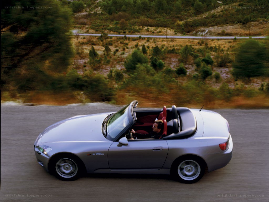 Silver convertible driving on road