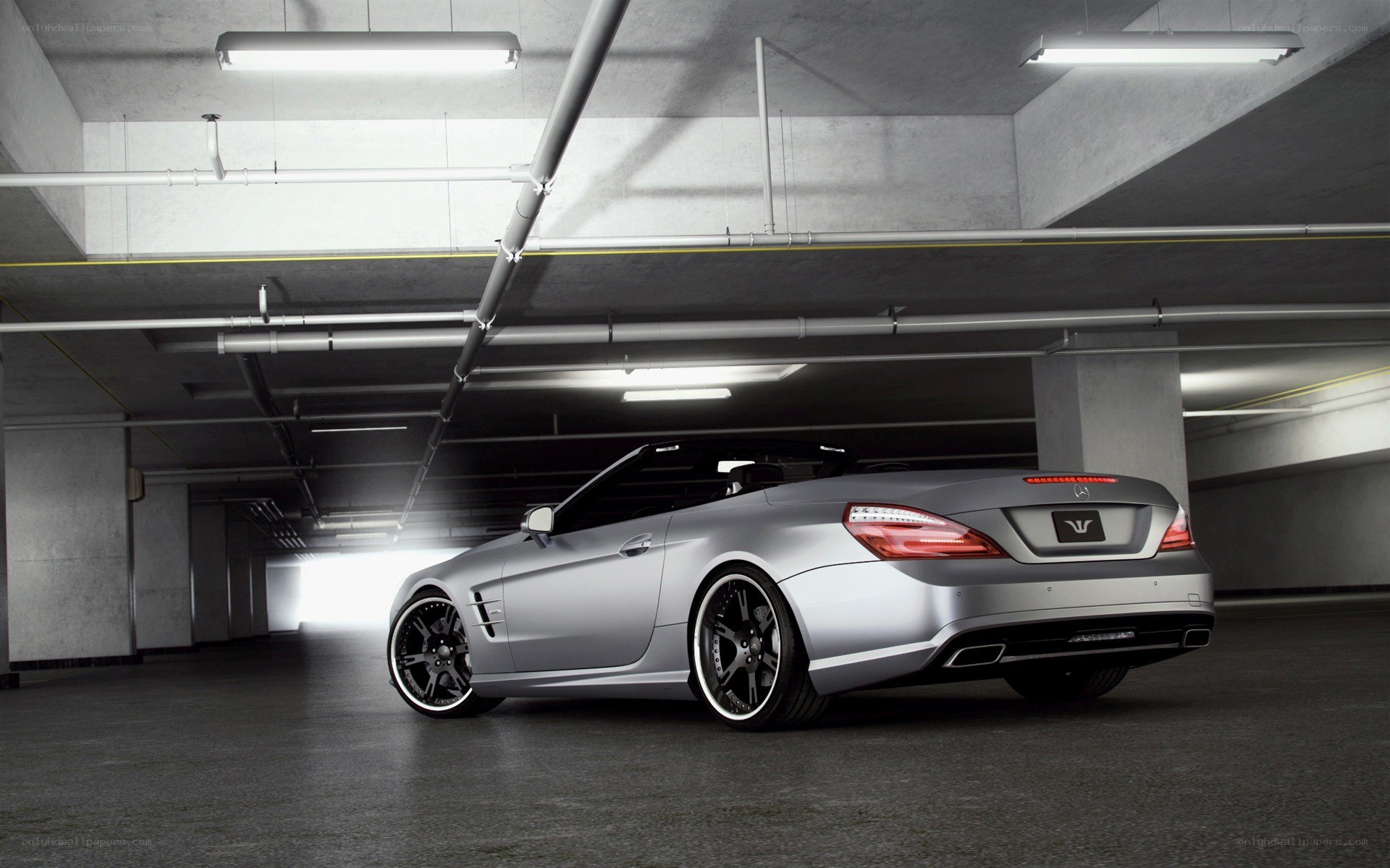 silver convertible in garage