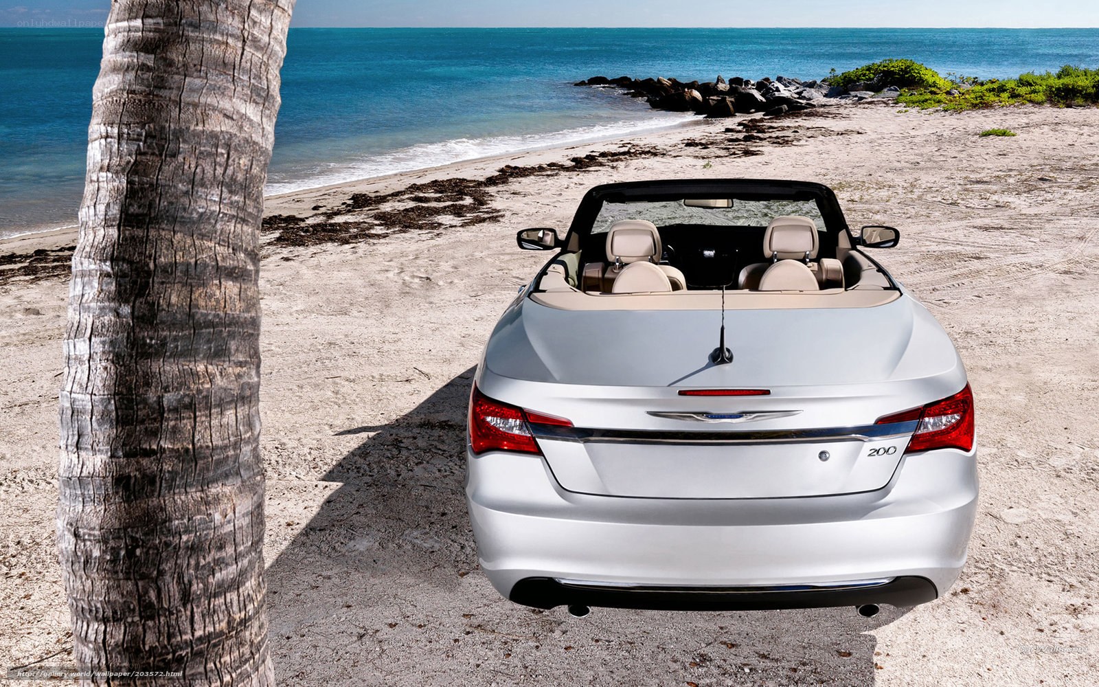 Silver convertible on beach