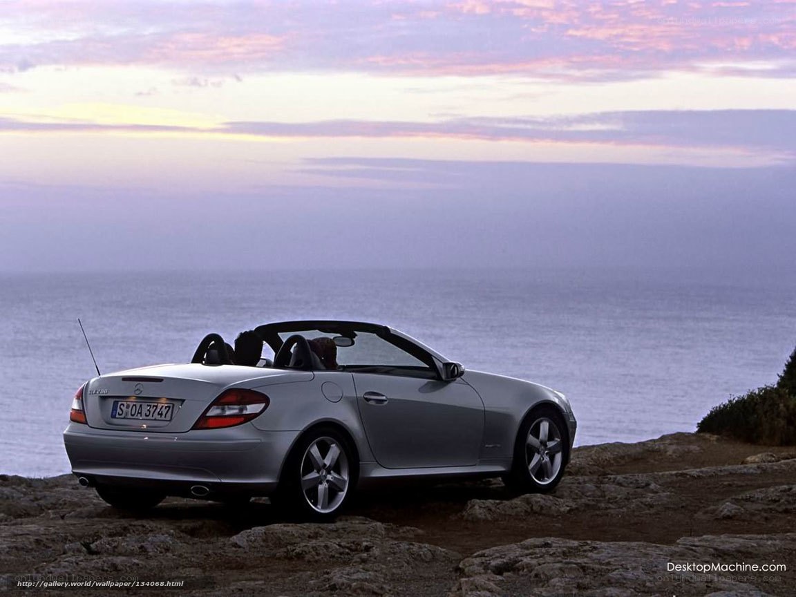 Silver convertible on cliffside