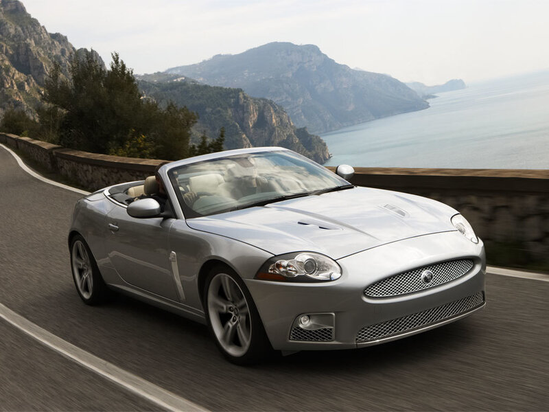 Silver convertible on coastal road