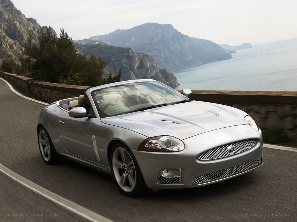 Silver convertible on coastal road
