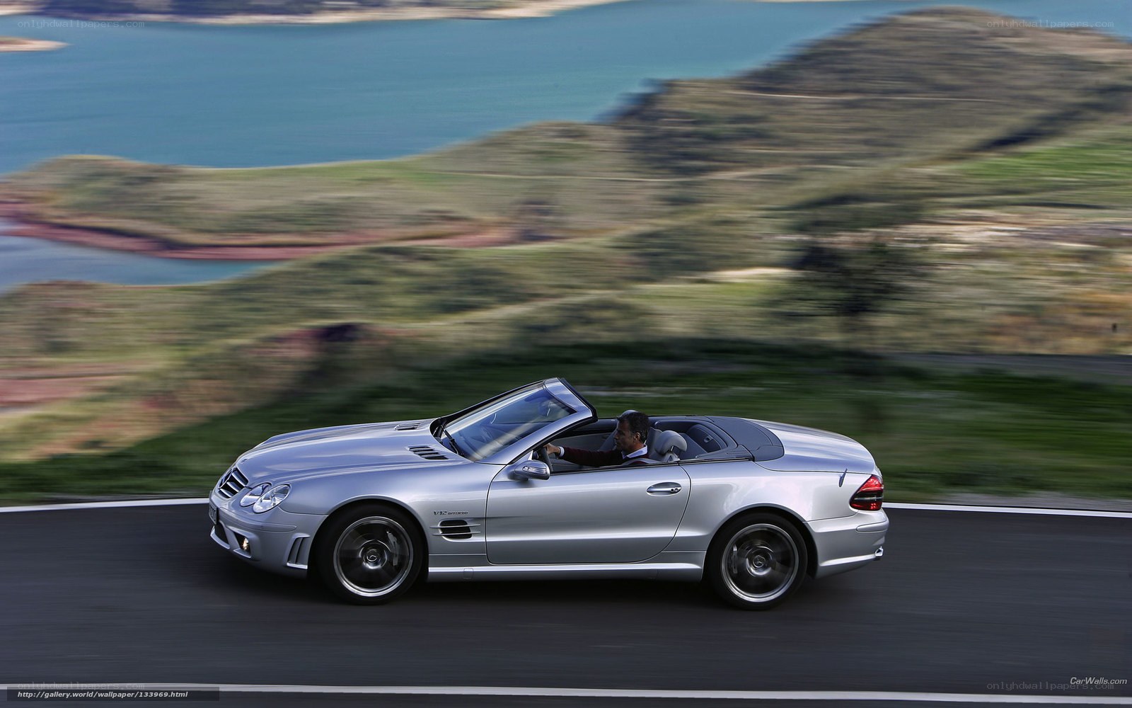 Silver convertible on coastal road