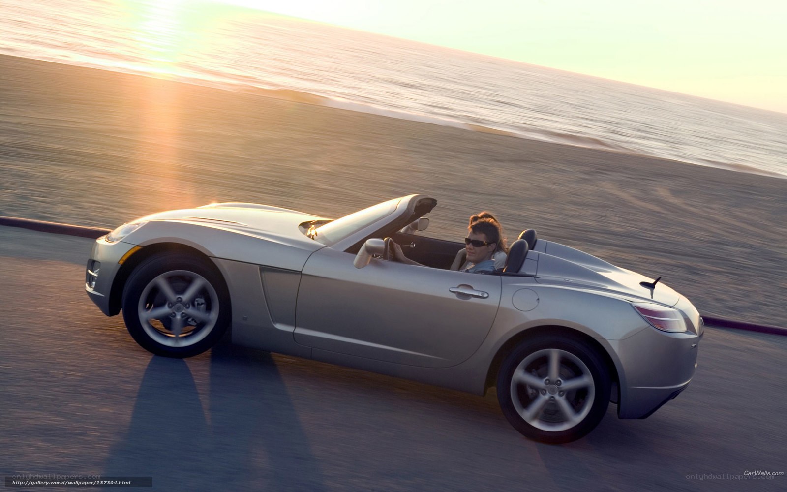 Silver convertible on coastal road