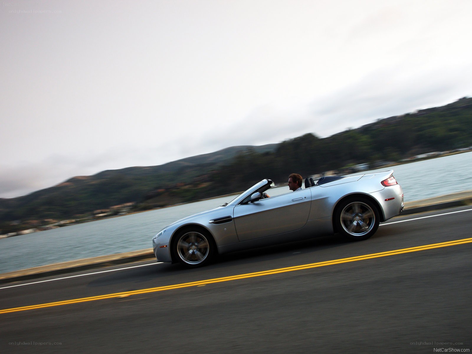 silver convertible on coastal road