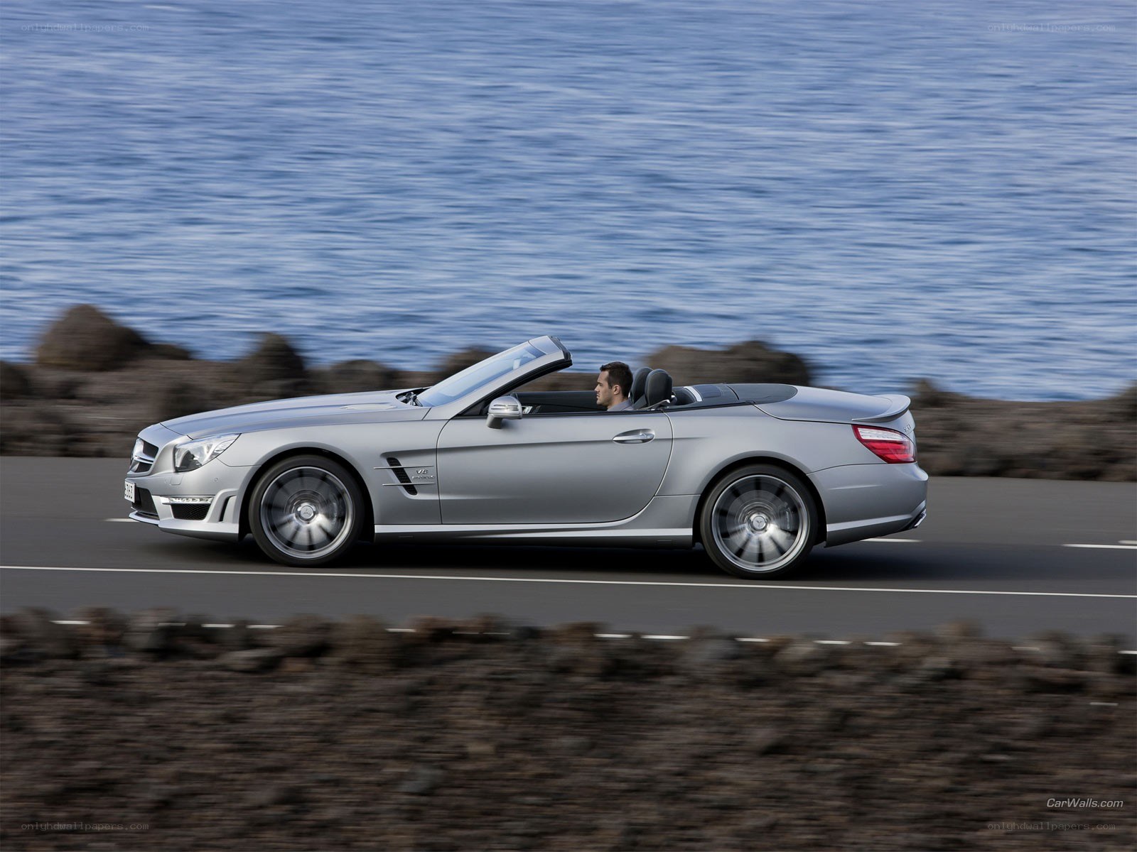 silver convertible on coastal road
