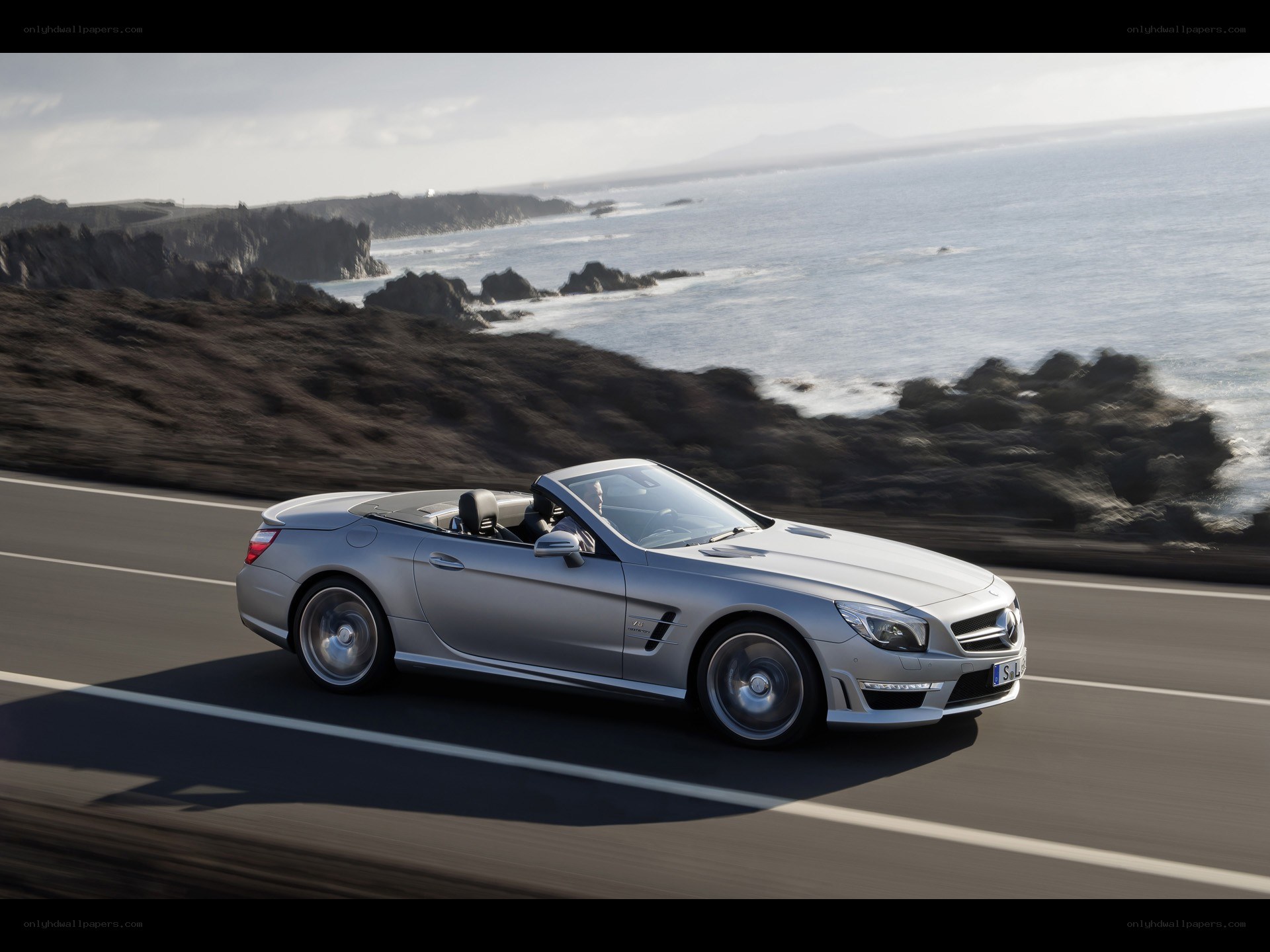 Silver convertible on coastal road