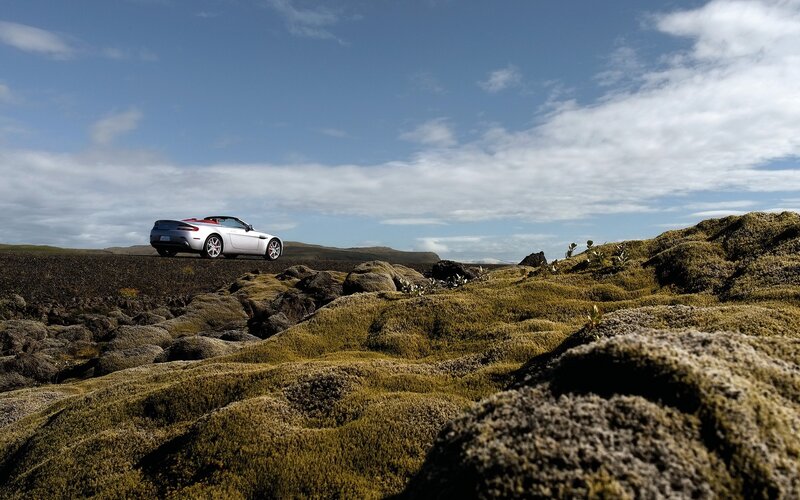 Silver convertible on mossy terrain