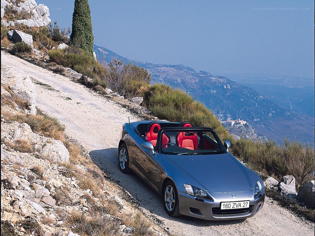 Silver convertible on mountain road