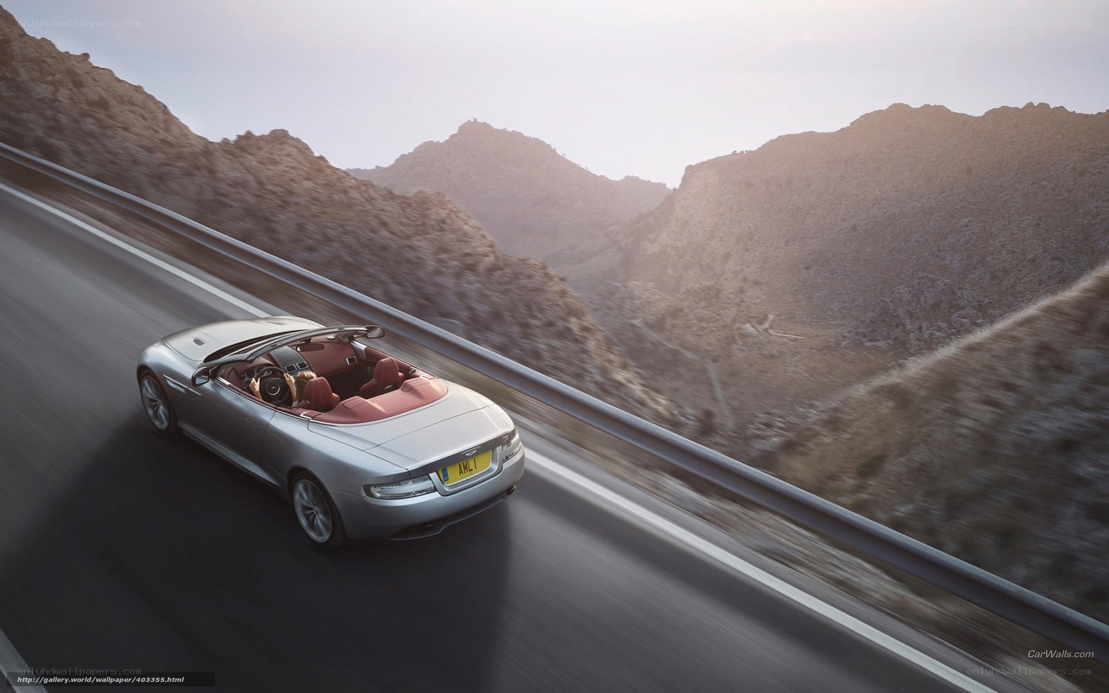 silver convertible on mountain road