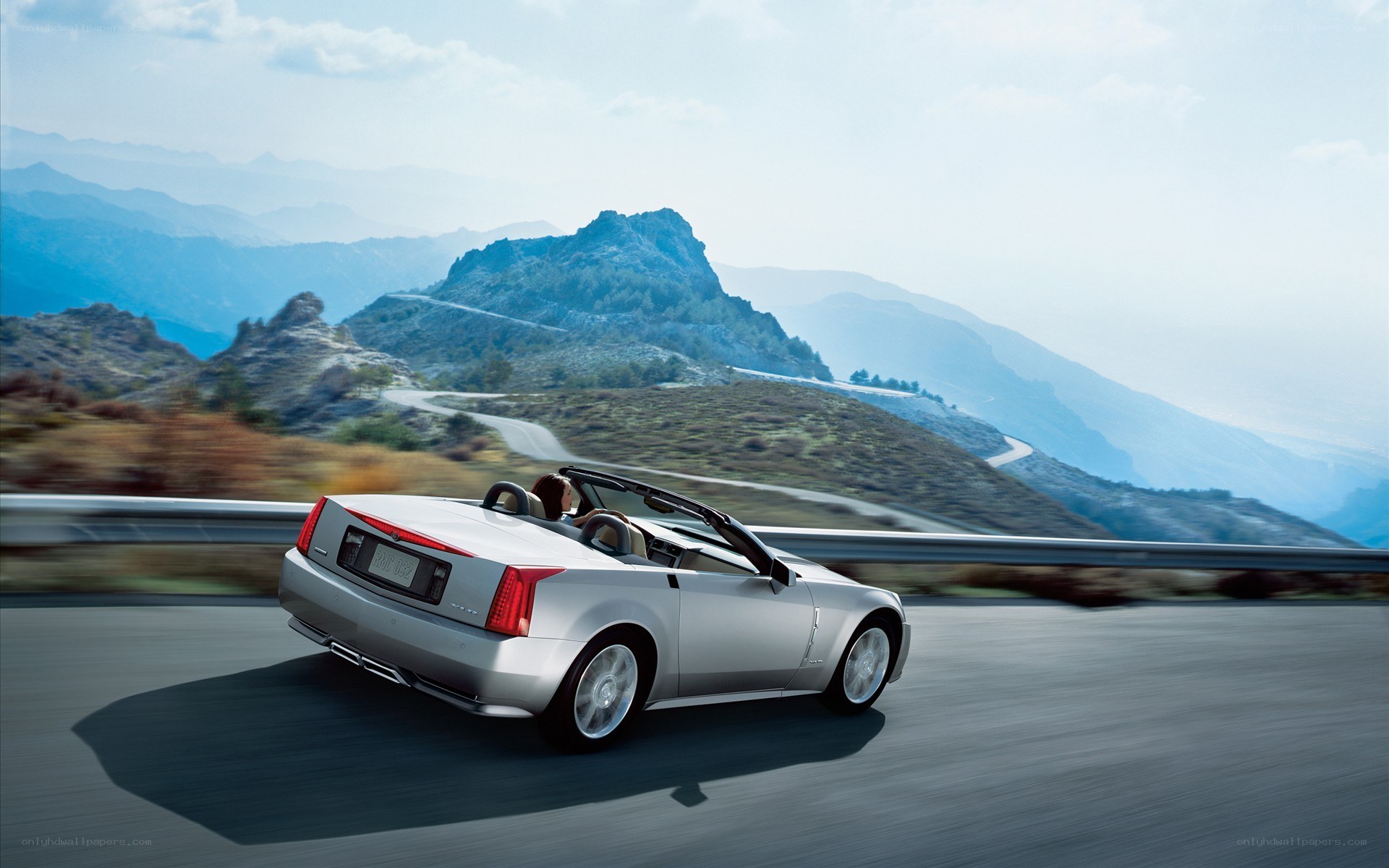 Silver convertible on mountain road