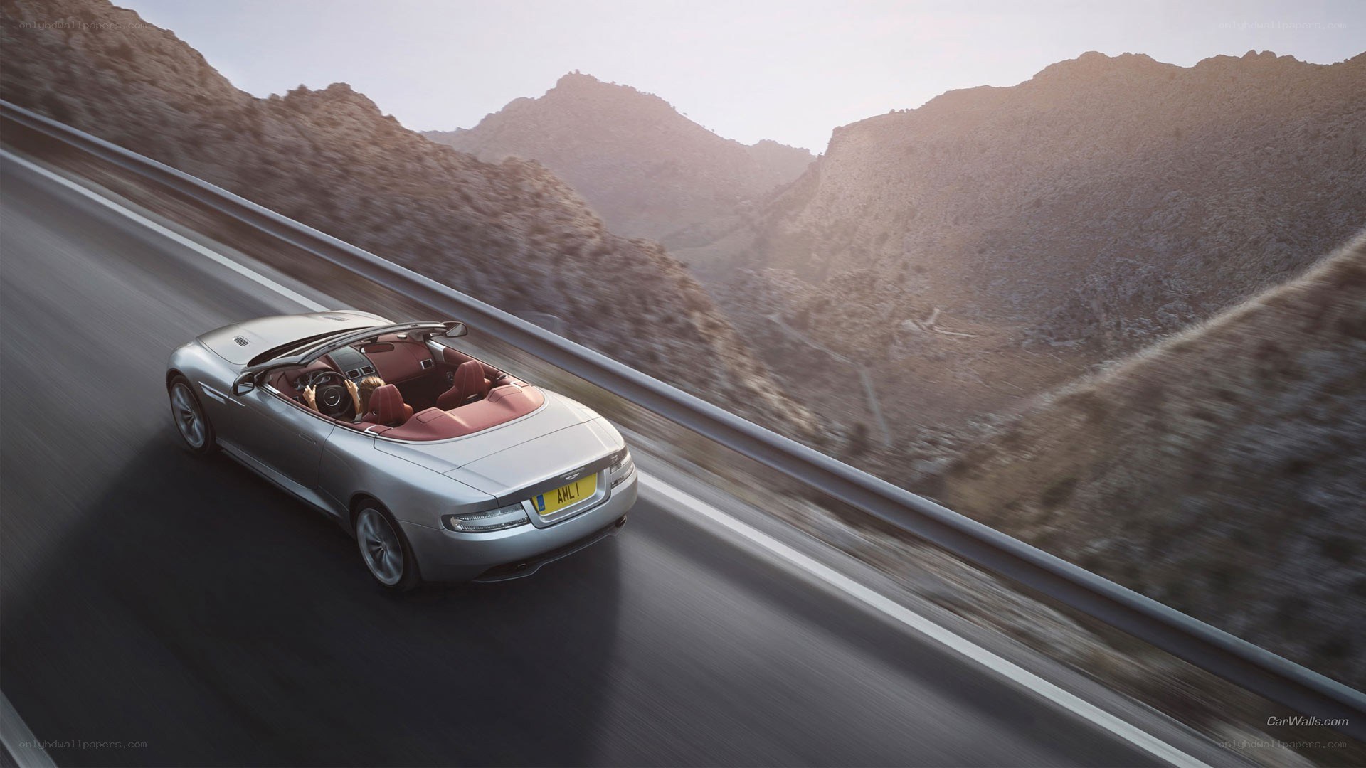 silver convertible on mountain road