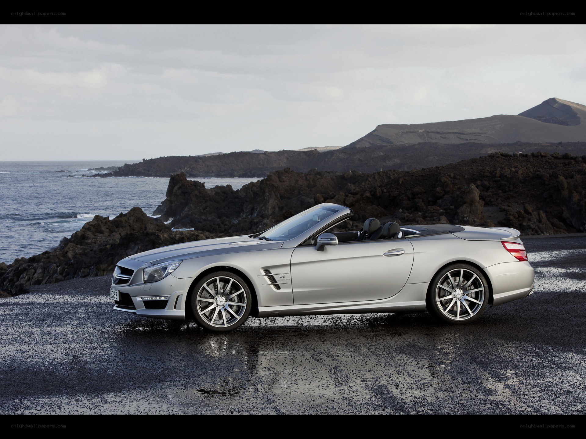 Silver convertible on rocky coast