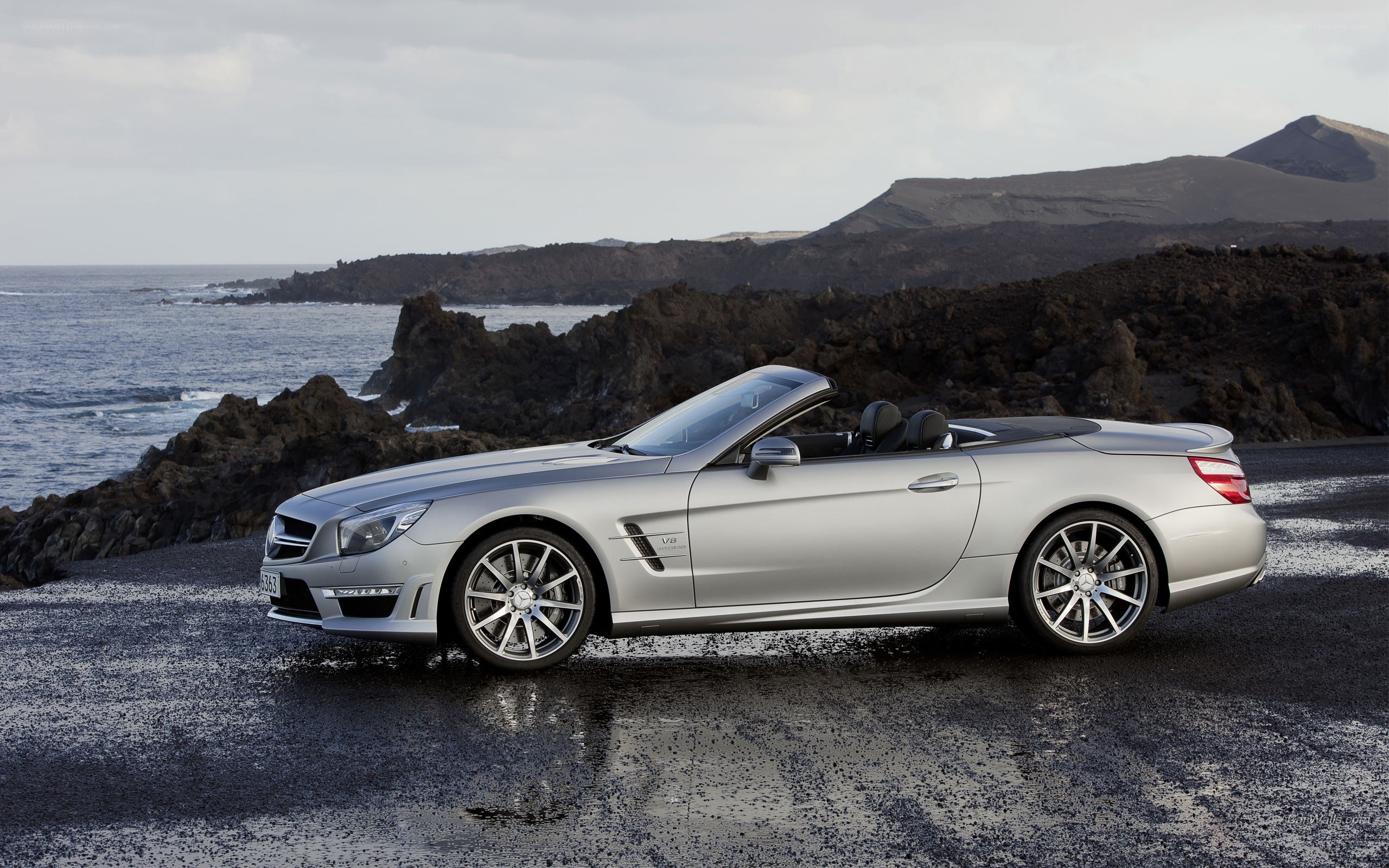 Silver convertible on rocky coast