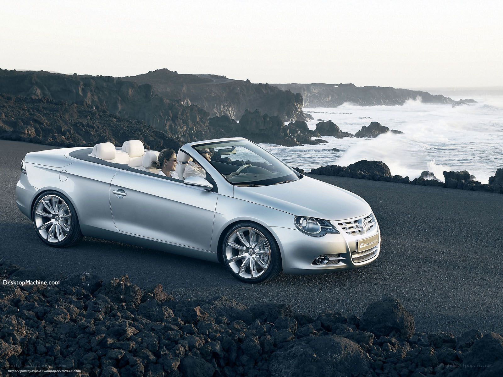 Silver convertible on rocky coast