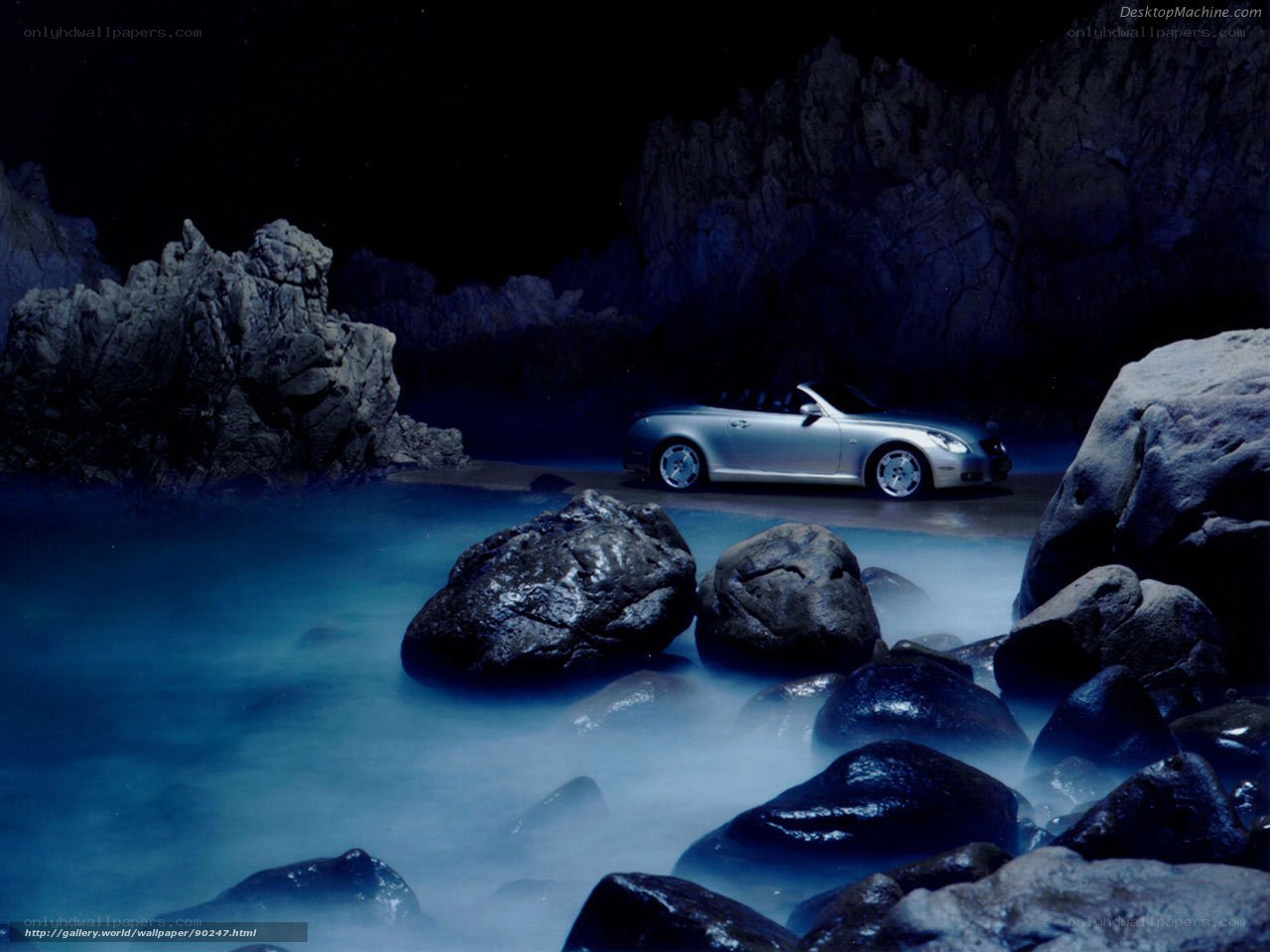 Silver convertible on rocky shore
