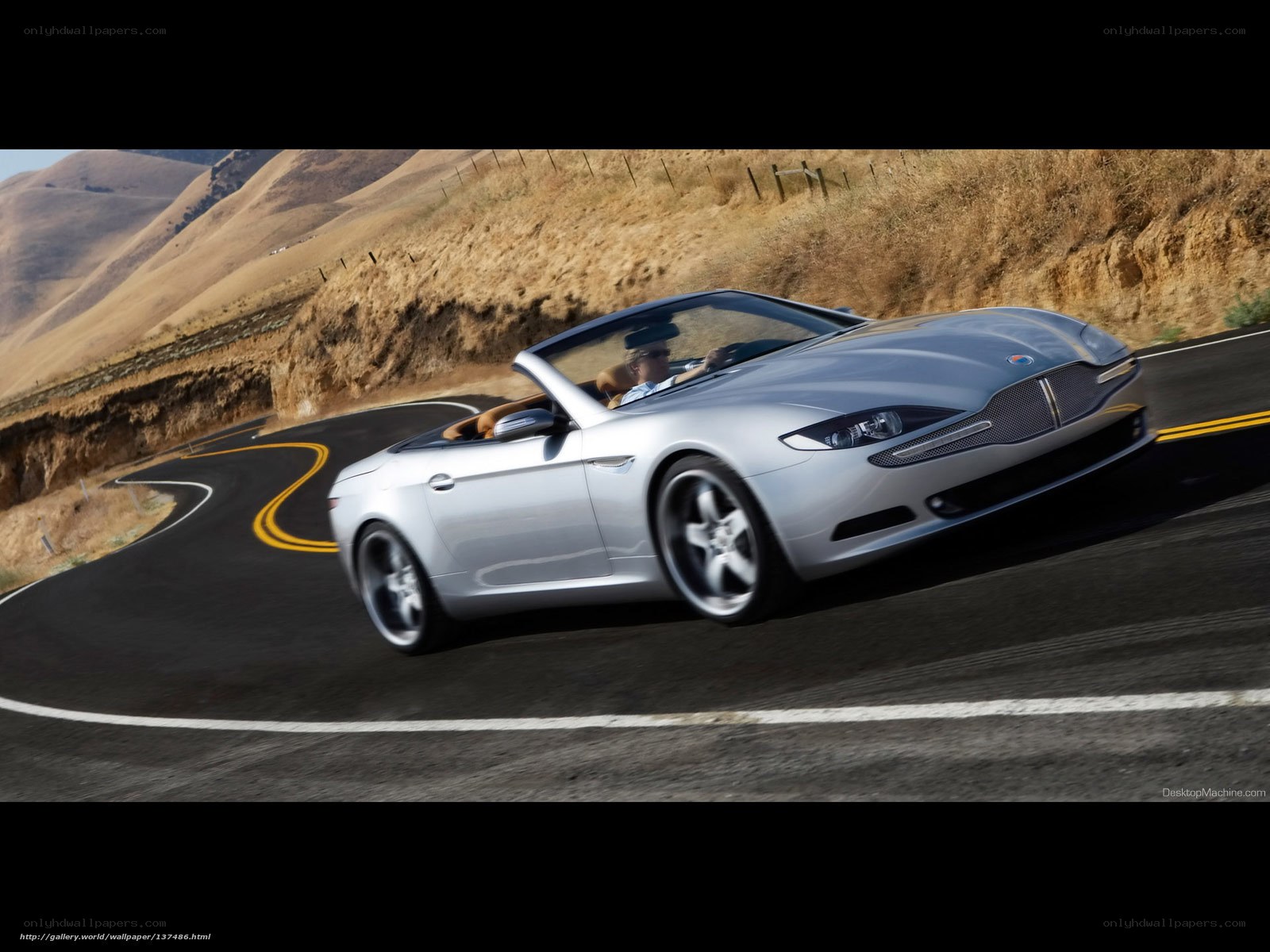 Silver convertible on winding road